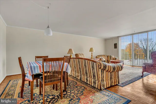 a view of a room with lots of furniture and windows