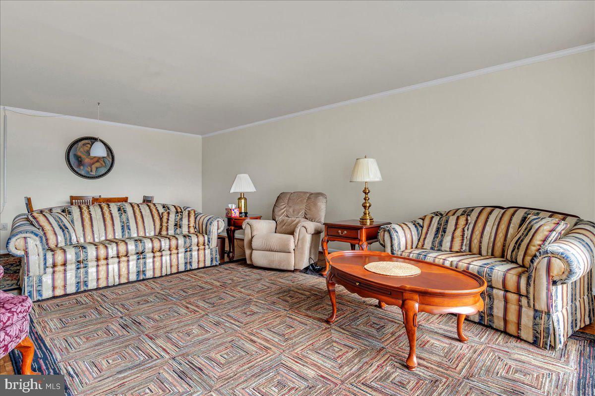 1403 Shallcross Avenue, Unit 310 Wilmington, DE 19806 - Photo 10 of 21 a living room with furniture a rug and a table