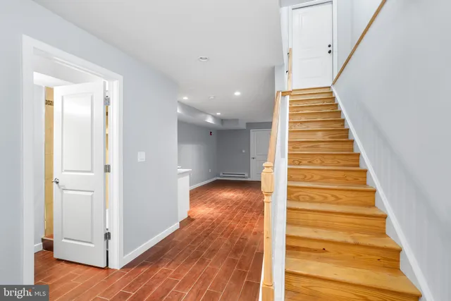 a view of a hallway with wooden floor and entryway