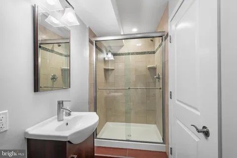 a bathroom with a shower and mirror