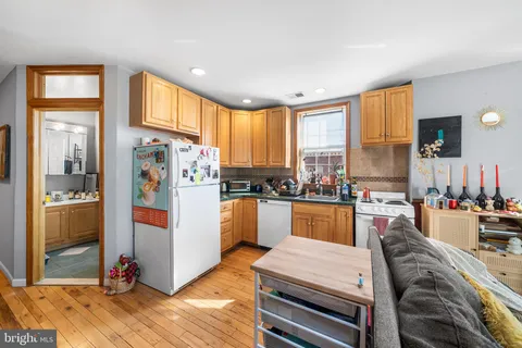 a kitchen with a refrigerator and a stove top oven