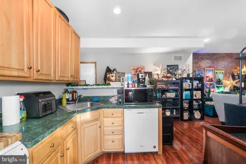 a kitchen with stainless steel appliances granite countertop a refrigerator sink and cabinets