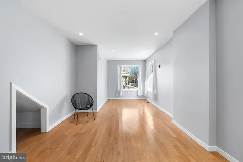 a view of a room with wooden floor and stairs