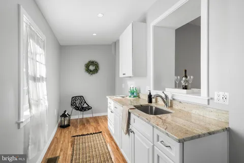 a kitchen with a sink stove and cabinets