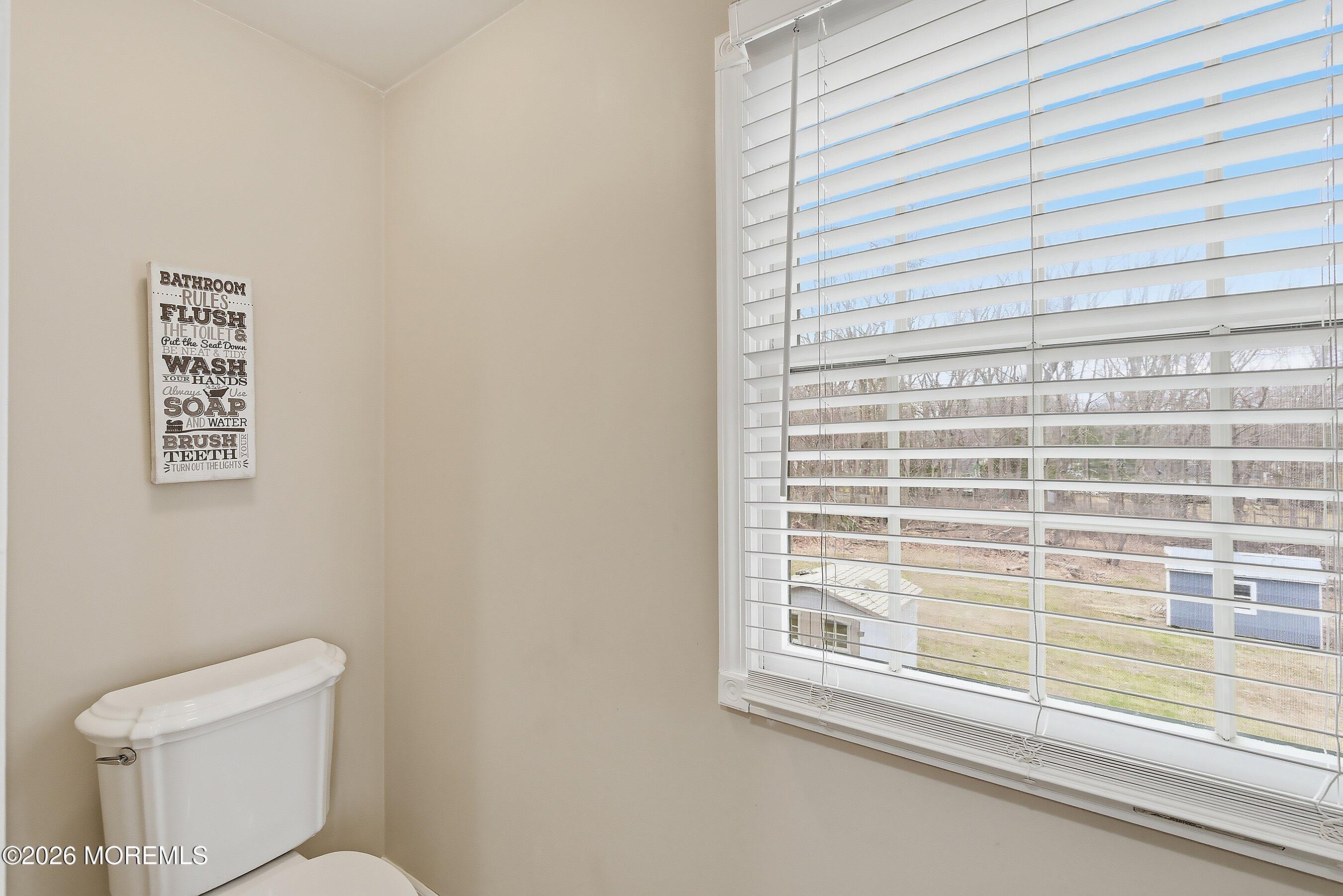 219 Stuart Street Howell, NJ 07731 - Photo 19 of 36 a bathroom with a toilet a sink and a window