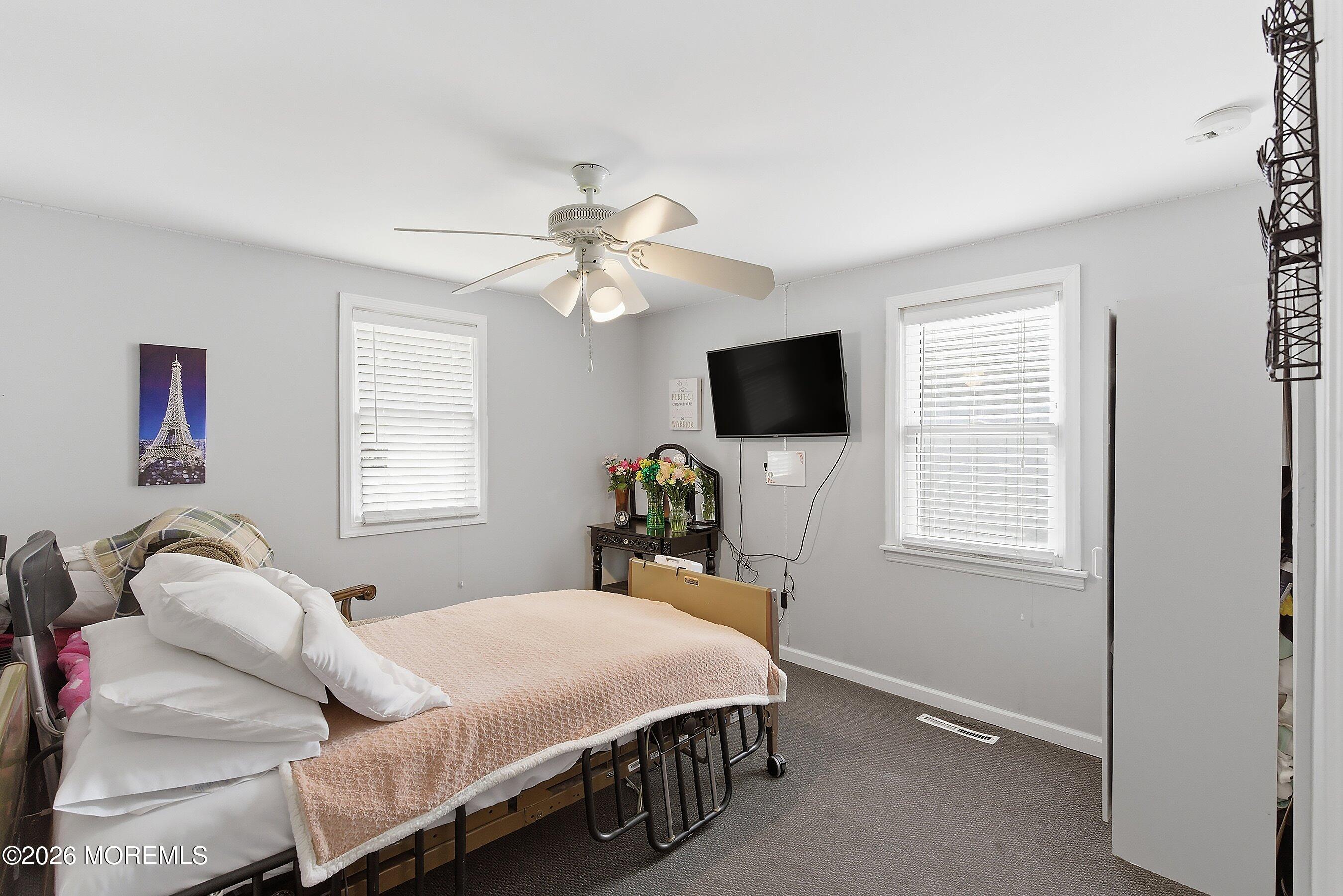 219 Stuart Street Howell, NJ 07731 - Photo 22 of 36 a bedroom with a bed and a flat screen tv