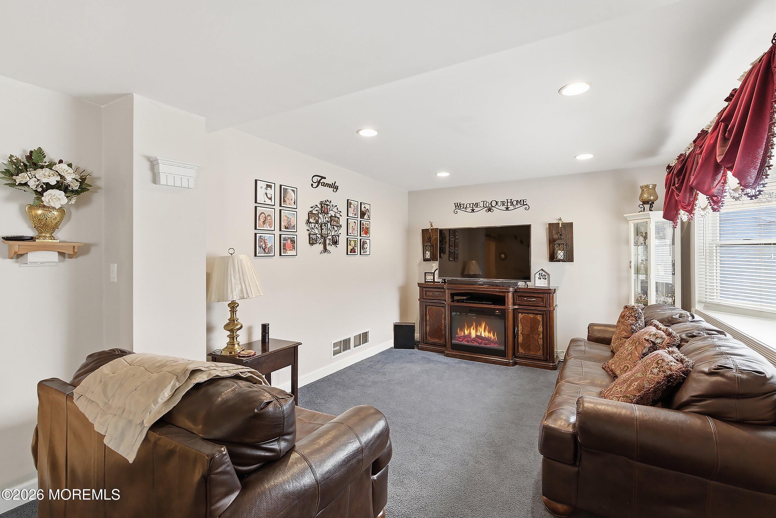 219 Stuart Street Howell, NJ 07731 - Photo 6 of 36 a living room with furniture and a flat screen tv