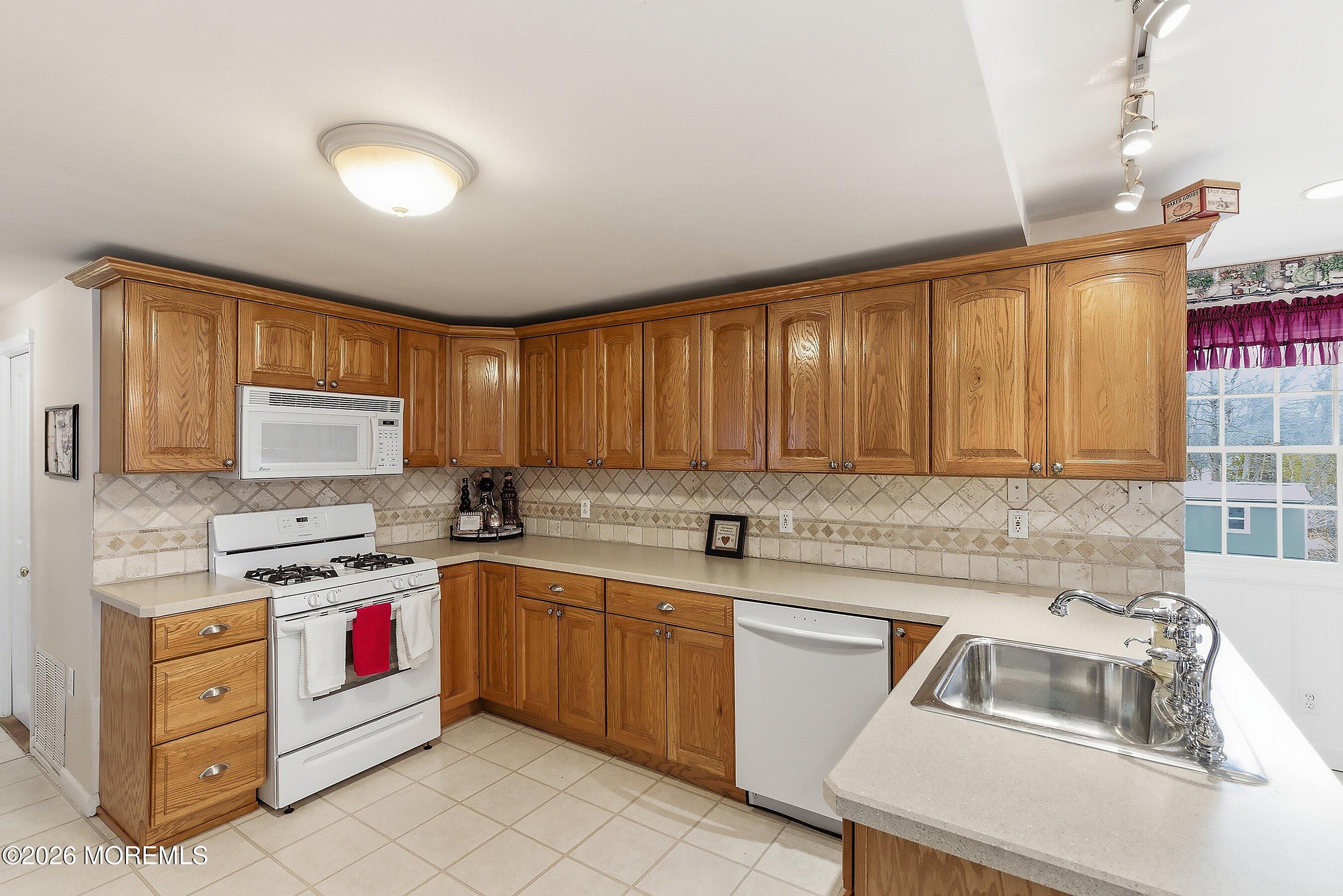 219 Stuart Street Howell, NJ 07731 - Photo 8 of 36 a kitchen that has a sink and a stove in it
