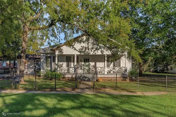 a front view of a house with a yard table and chairs