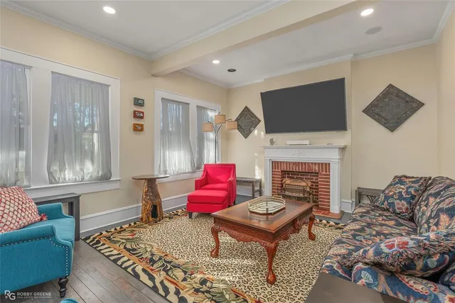 a living room with furniture a flat screen tv and a fireplace