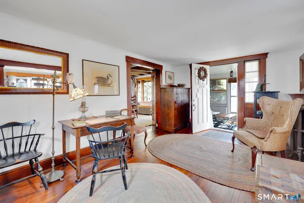 a dining room with furniture and wooden floor