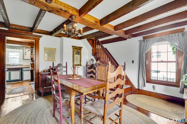 a dining room with furniture and wooden floor