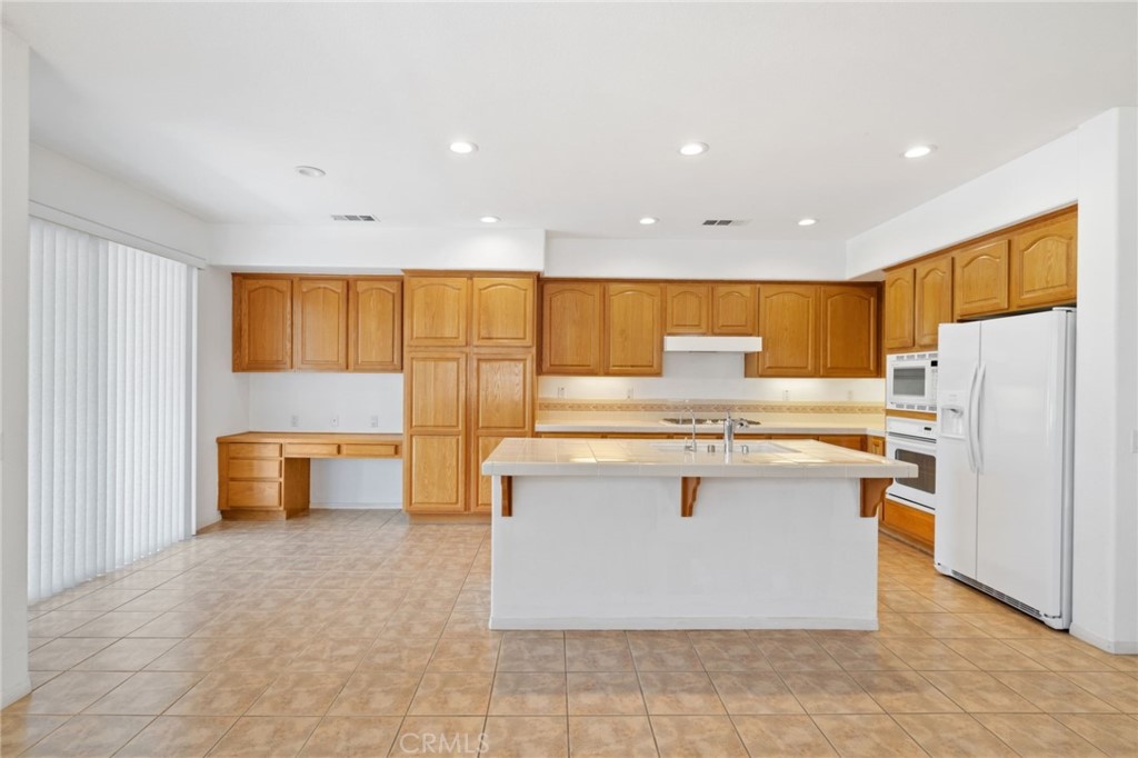 31256 Firestone Street Temecula, CA 92591 - Photo 17 of 56 a kitchen with stainless steel appliances granite countertop a stove and a refrigerator