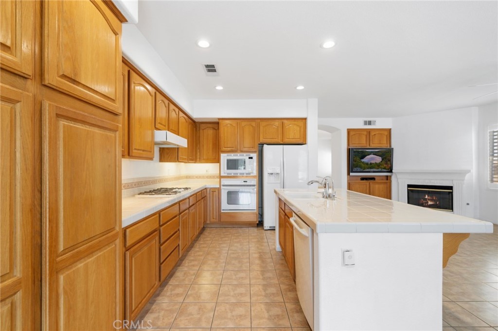 31256 Firestone Street Temecula, CA 92591 - Photo 19 of 56 a kitchen with stainless steel appliances granite countertop a stove and a refrigerator