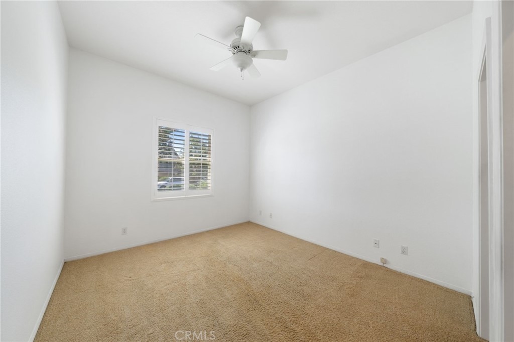 31256 Firestone Street Temecula, CA 92591 - Photo 21 of 56 an empty room with a window and a ceiling fan