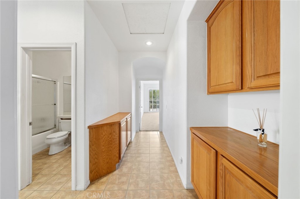 31256 Firestone Street Temecula, CA 92591 - Photo 27 of 56 a hallway with a sink and a toilet