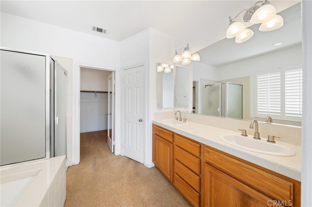 31256 Firestone Street Temecula, CA 92591 - Photo 30 of 56 a spacious bathroom with a double vanity sink and a mirror