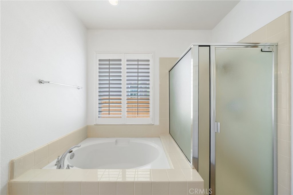 31256 Firestone Street Temecula, CA 92591 - Photo 31 of 56 a bathroom with a bathtub and a shower