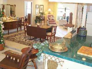 113 North W Everglades Boulevard Stuart, FL 34994 - Photo 2 of 8 a living room with fireplace furniture and a floor to ceiling window