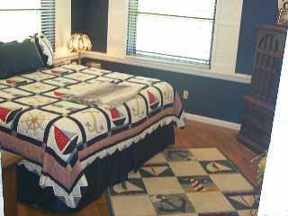 113 North W Everglades Boulevard Stuart, FL 34994 - Photo 4 of 8 a bed sitting in a bedroom next to a window
