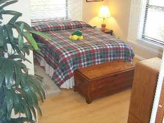 113 North W Everglades Boulevard Stuart, FL 34994 - Photo 5 of 8 a bed sitting in a bedroom next to a window