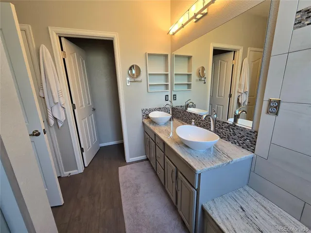 a bathroom with double vanity sink and mirror