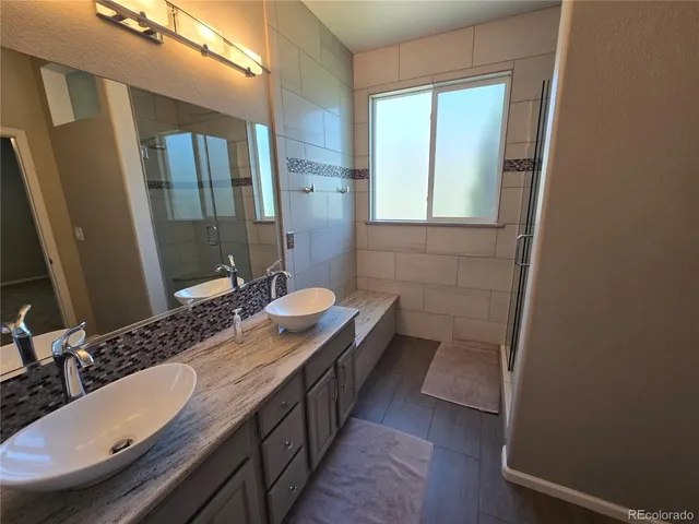 a bathroom with a double vanity sink and a mirror