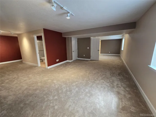 an empty room with closet and mirror