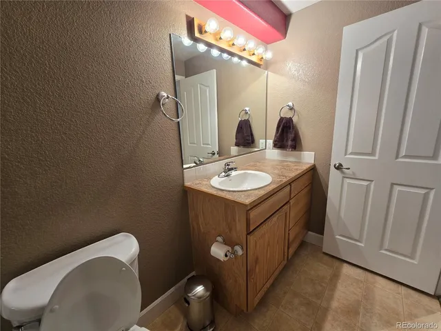 a bathroom with a sink a toilet and mirror