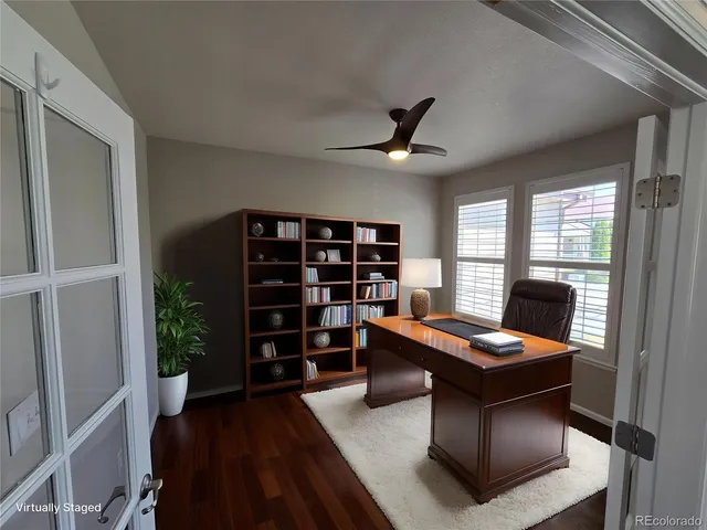 a view of a workspace with furniture and a window