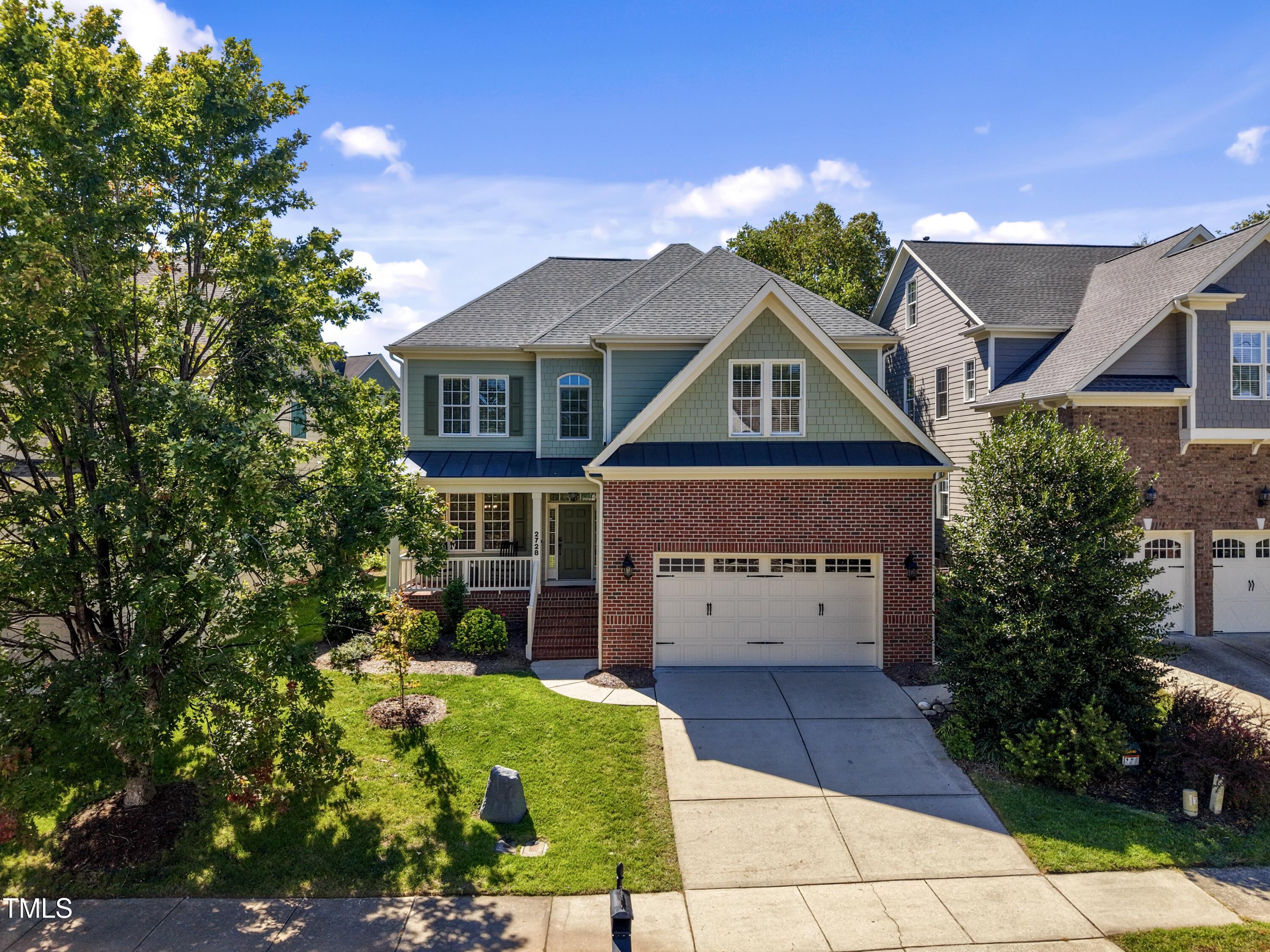a front view of a house with a garden and plants