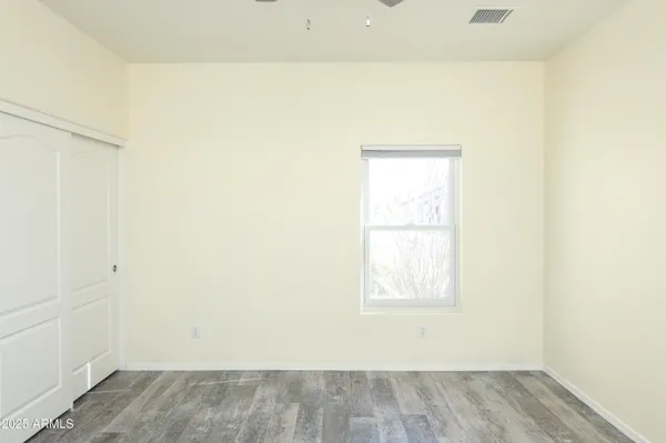a view of a small space with wooden floor and a window