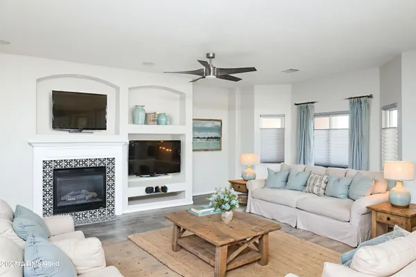 a living room with furniture a fireplace and a flat screen tv