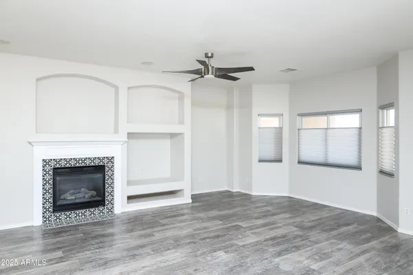 a view of empty room with a fireplace