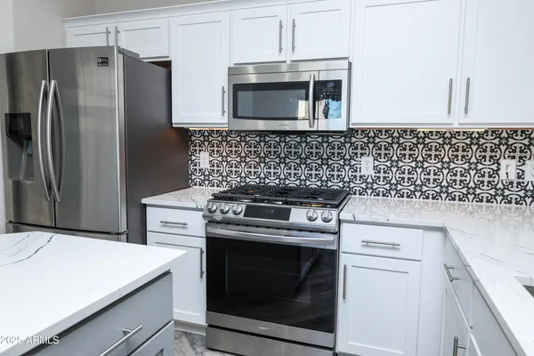 a kitchen with a stove microwave and refrigerator