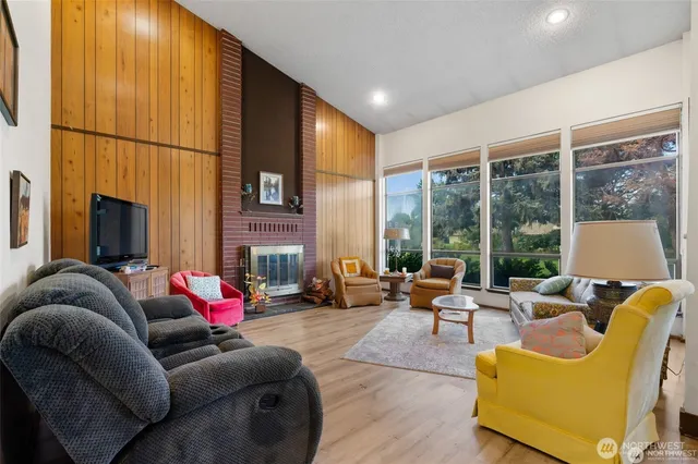 a living room with furniture or floor to ceiling windows and a flat screen tv