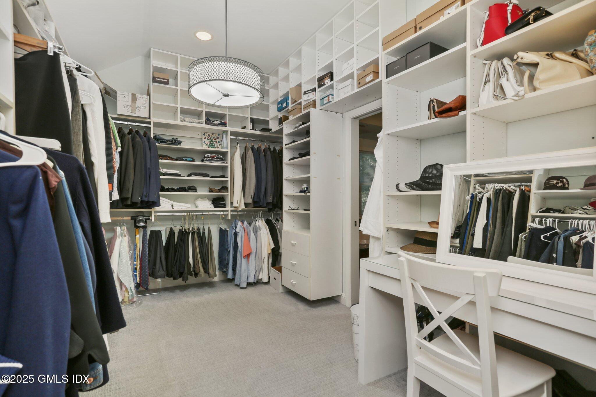 112 Old Belden Hill Road Wilton, CT 06897 - Photo 13 of 38 a view of walk in closet with clothes and shoes