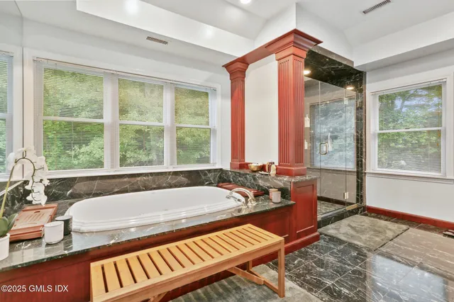 a spacious bathroom with a granite countertop sink and a mirror