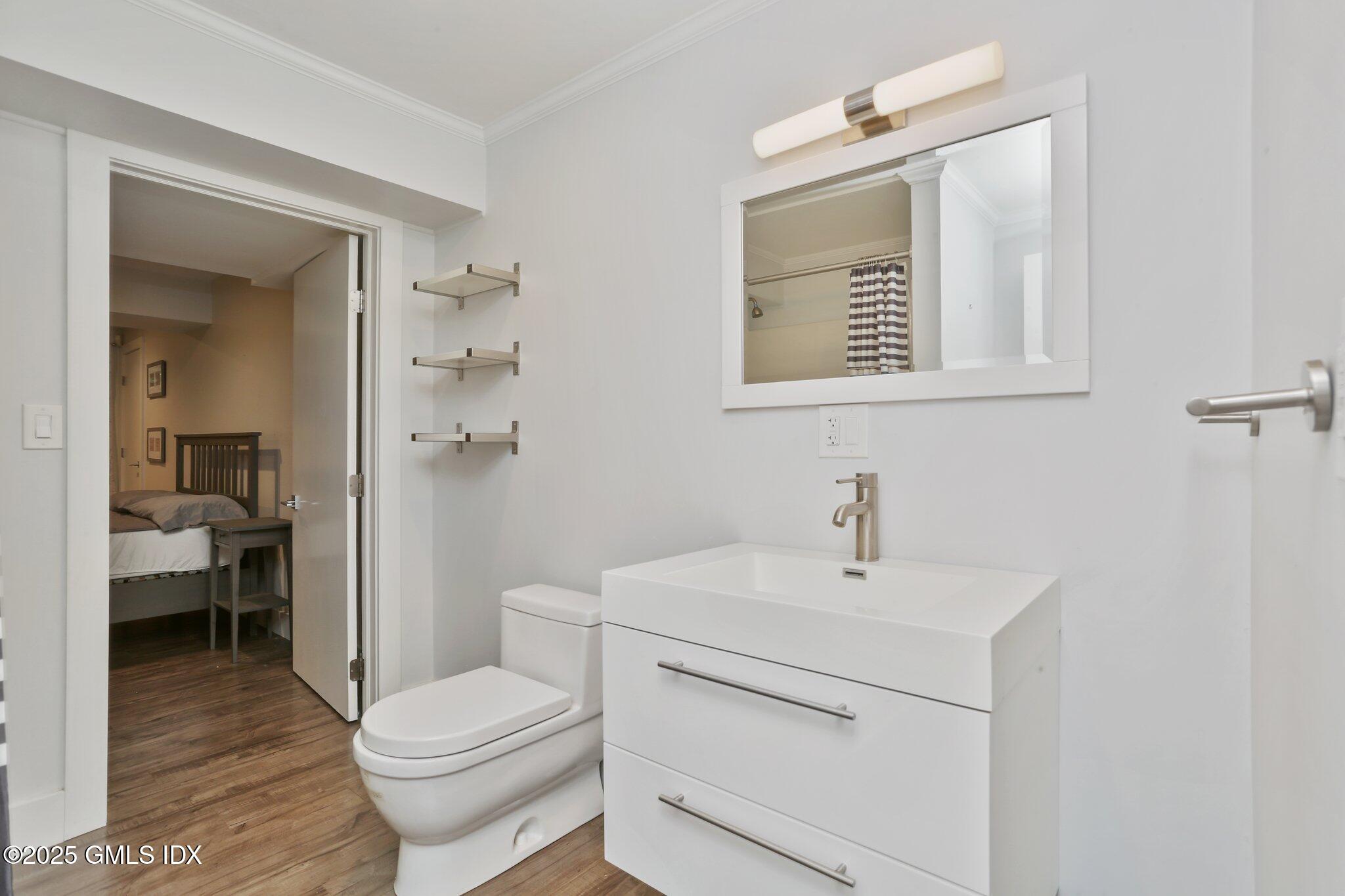 112 Old Belden Hill Road Wilton, CT 06897 - Photo 26 of 38 a bathroom with a toilet a sink and mirror