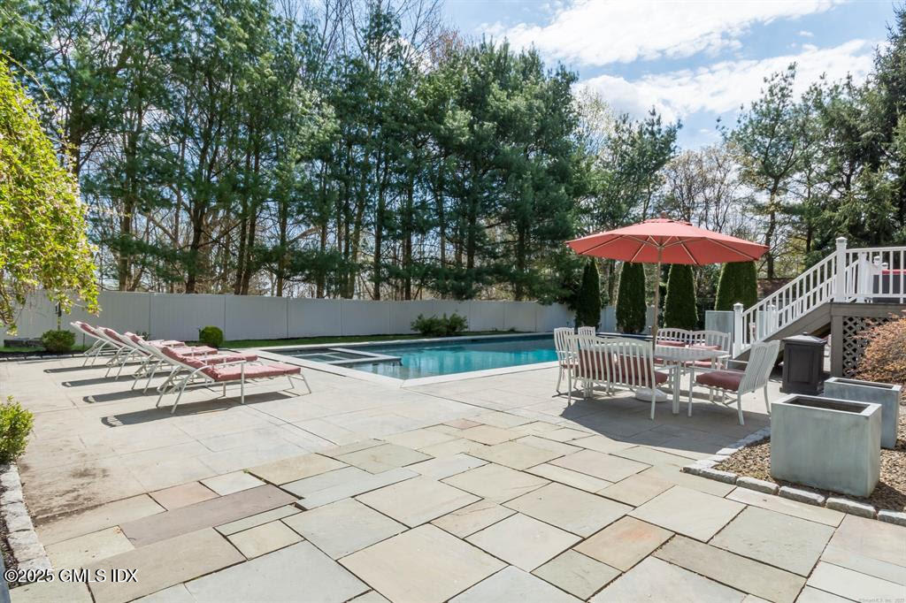 112 Old Belden Hill Road Wilton, CT 06897 - Photo 28 of 38 a view of table and chairs under an umbrella
