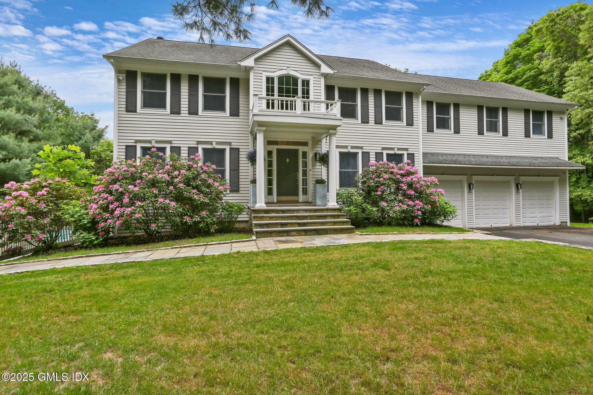 112 Old Belden Hill Road Wilton, CT 06897 - Photo 35 of 38 a front view of a house with a garden