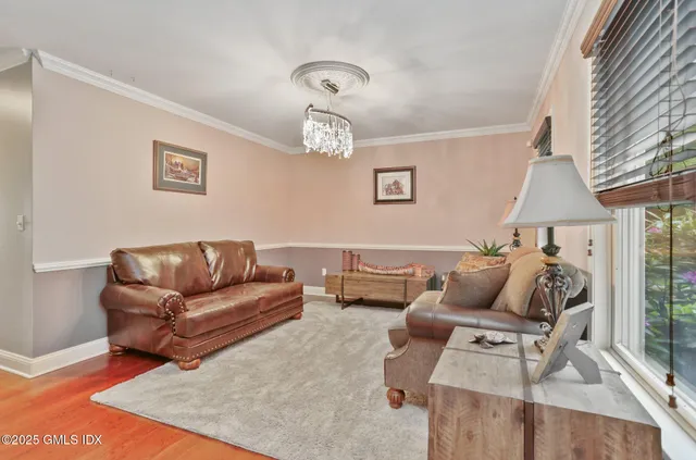 a living room with furniture and large windows