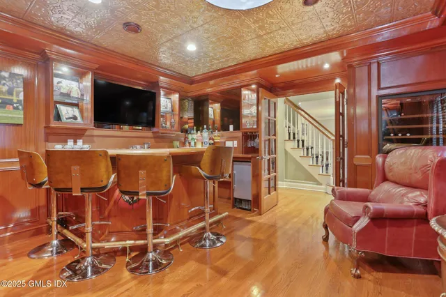 a dining room with furniture a chandelier and wooden floor