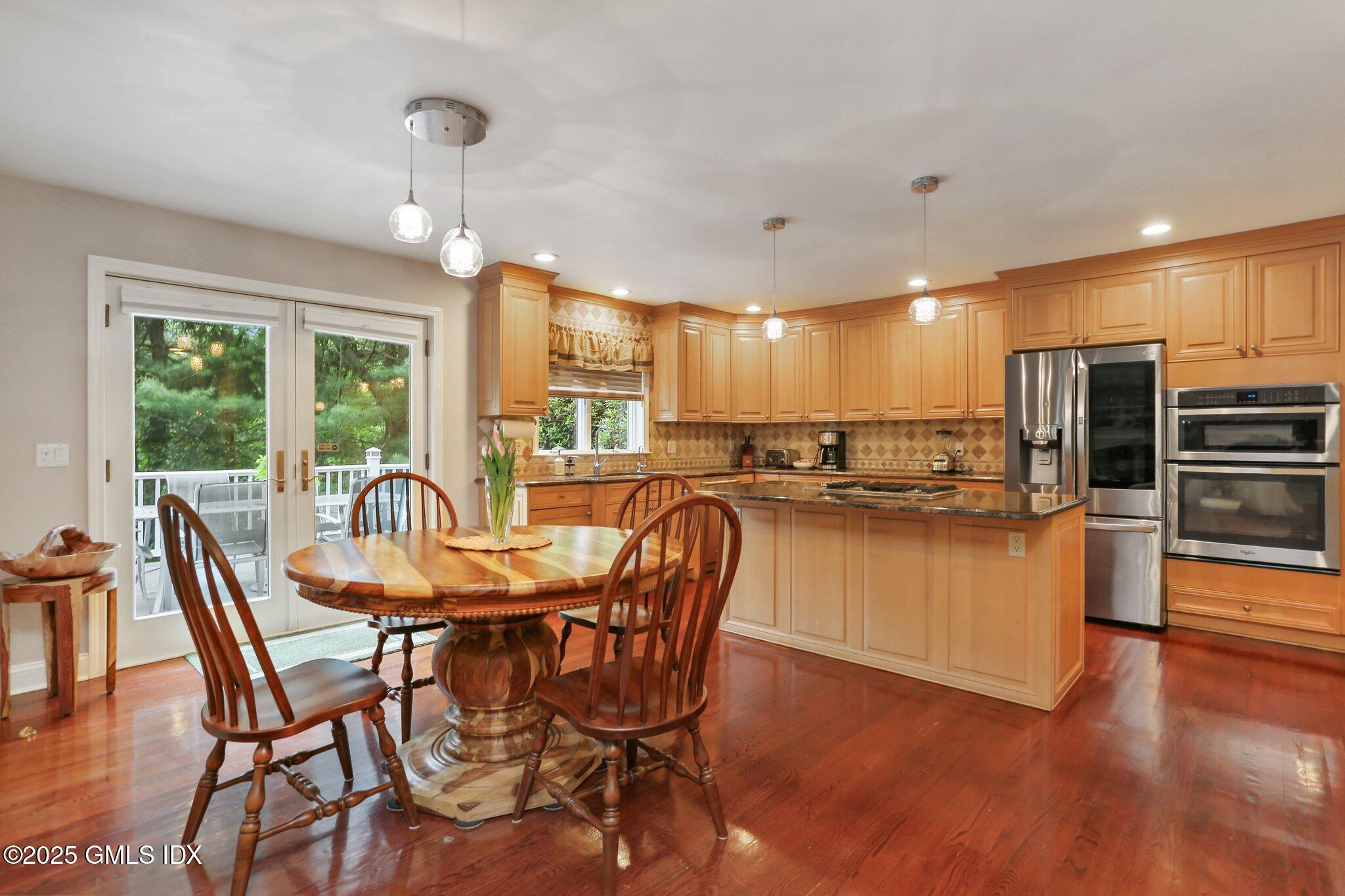 112 Old Belden Hill Road Wilton, CT 06897 - Photo 7 of 38 a dining room with furniture a chandelier and wooden floor