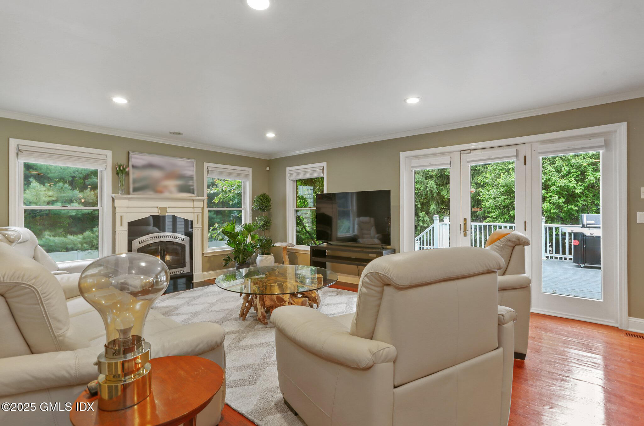 112 Old Belden Hill Road Wilton, CT 06897 - Photo 9 of 38 a living room with furniture a fireplace and a large window