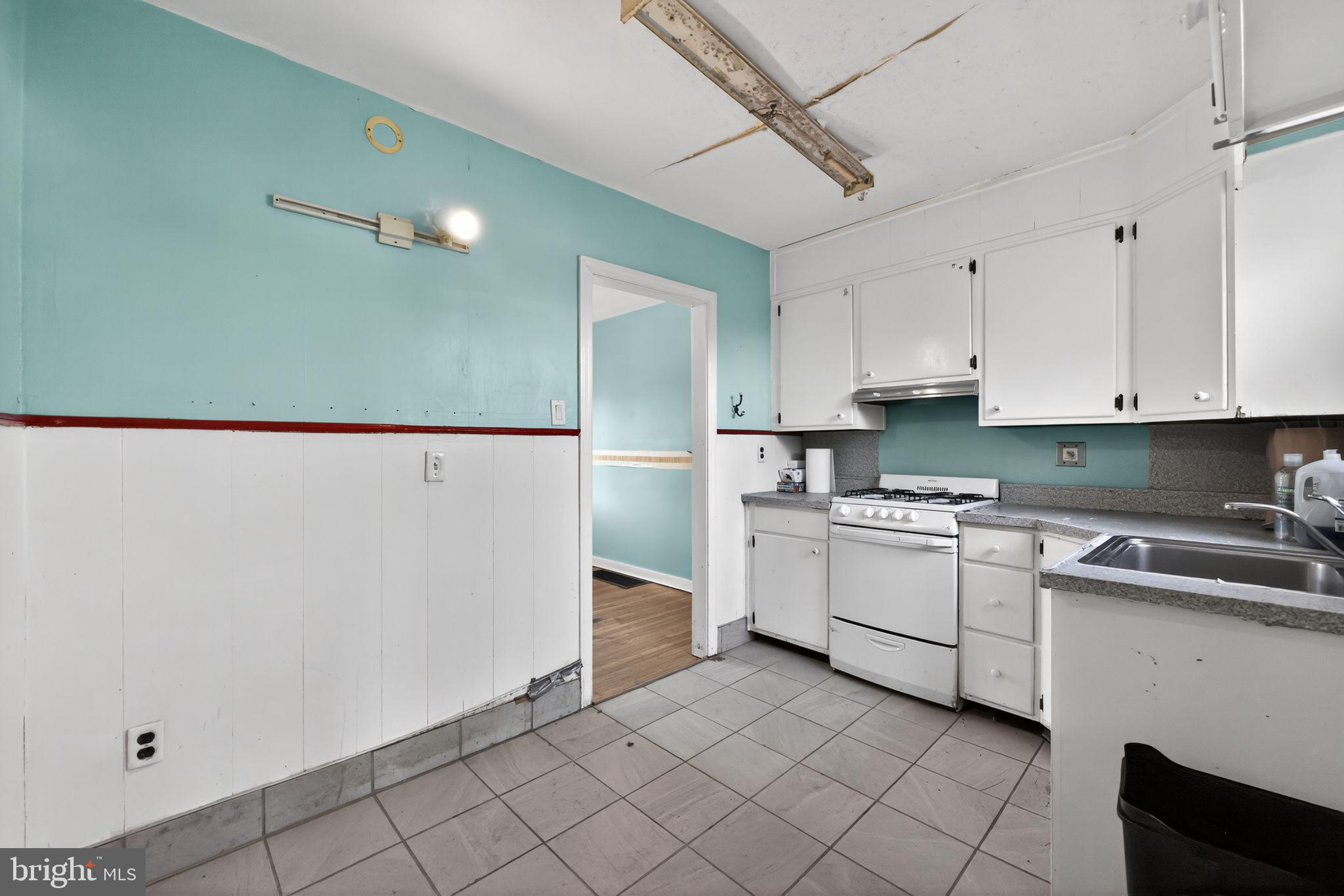 1212 Meadow Road Woodlyn, PA 19094 - Photo 15 of 30 a kitchen with white cabinets and white appliances