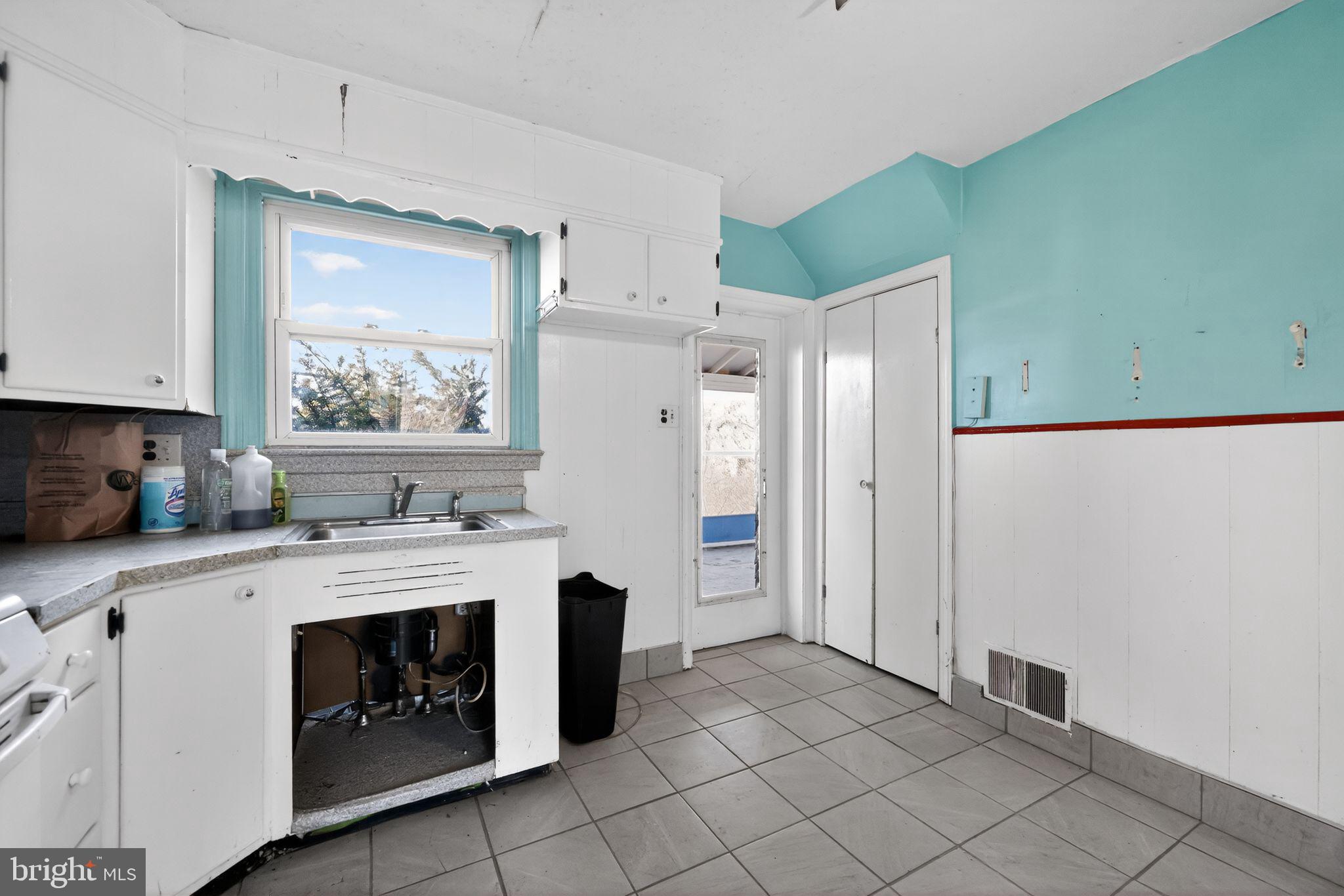 1212 Meadow Road Woodlyn, PA 19094 - Photo 16 of 30 a kitchen with a stove a sink and a refrigerator