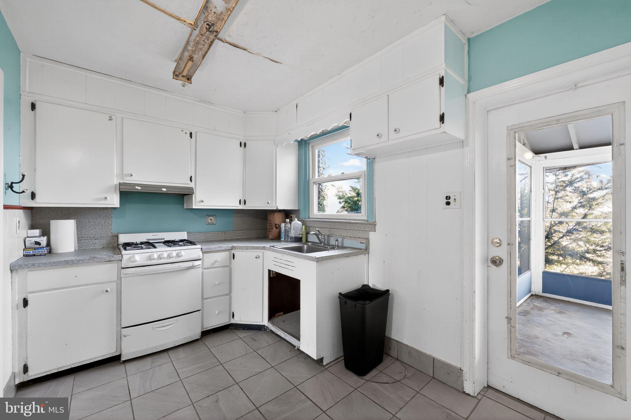 1212 Meadow Road Woodlyn, PA 19094 - Photo 17 of 30 a kitchen with white cabinets and white appliances