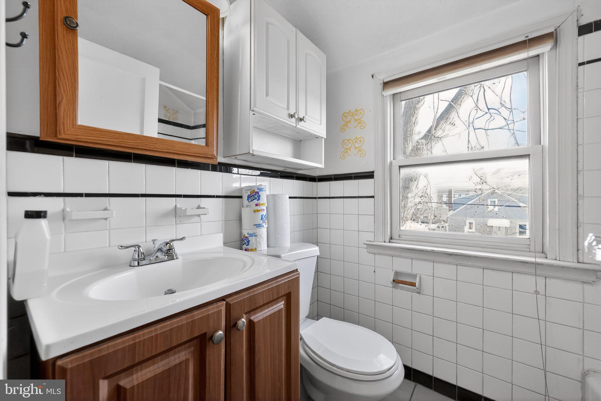 1212 Meadow Road Woodlyn, PA 19094 - Photo 27 of 30 a bathroom with a sink a toilet and window