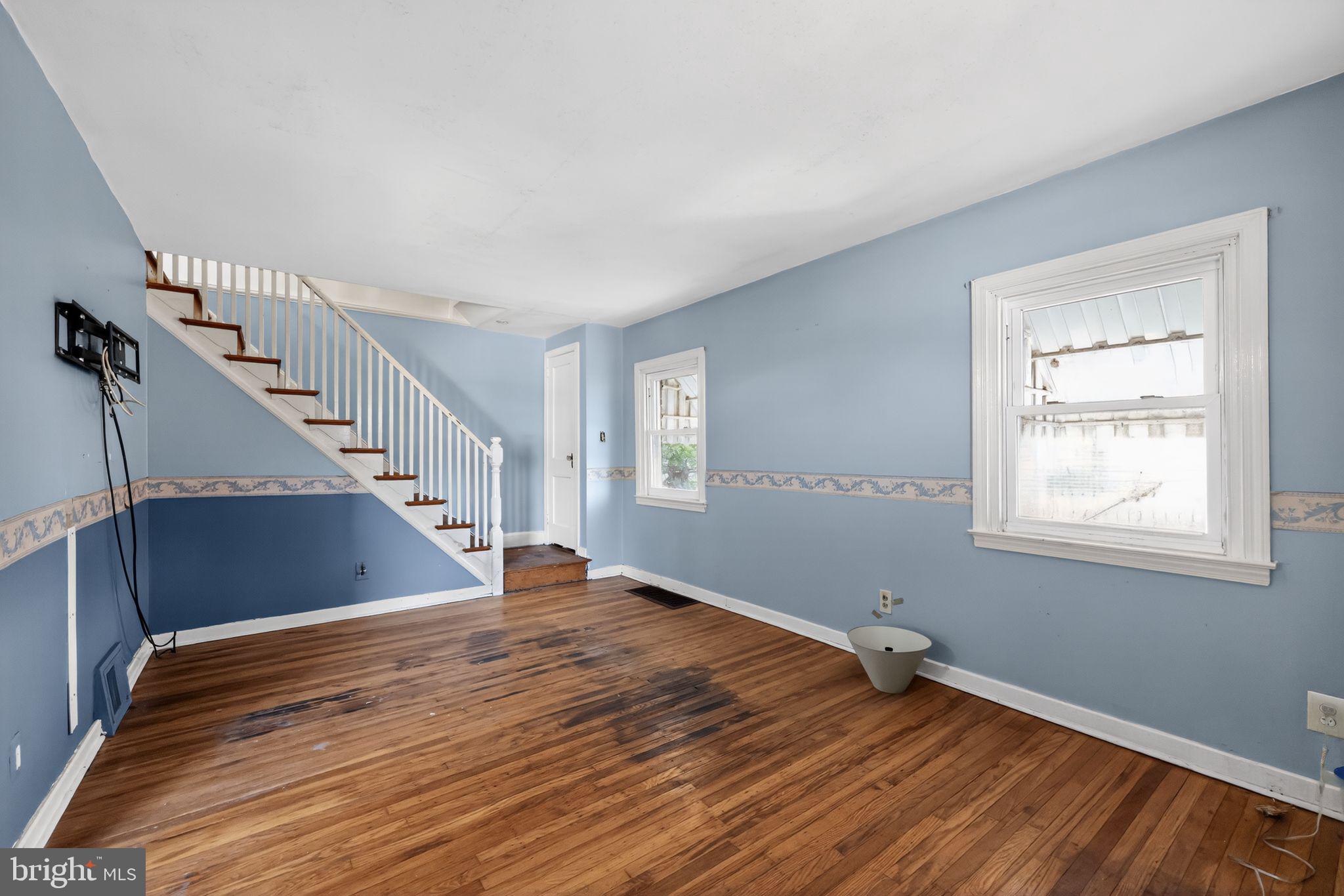 1212 Meadow Road Woodlyn, PA 19094 - Photo 7 of 30 a view of an empty room with wooden floor and fan